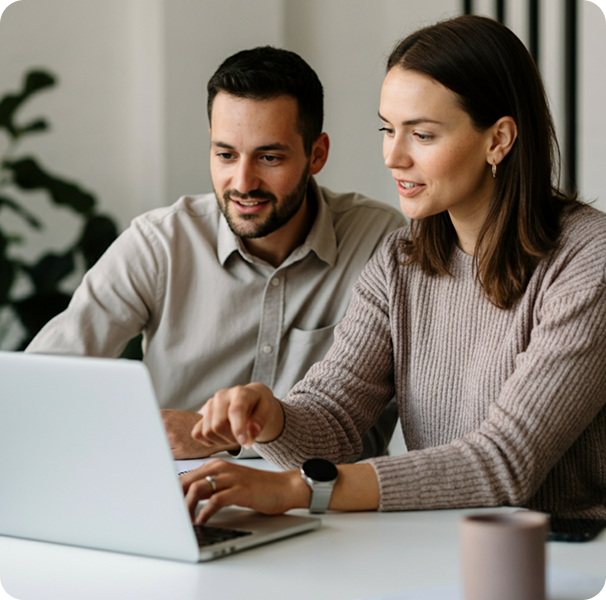 Two people reviewing products on a laptop